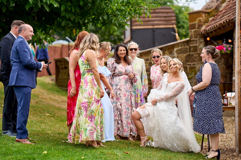 Candid wedding photography capturing guests laughing naturally during the reception.