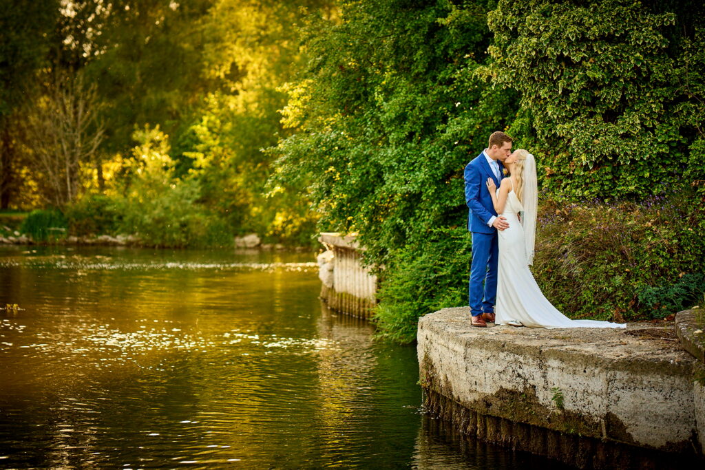 A newlywed bride and groom kissing outside their Coventry wedding venue.