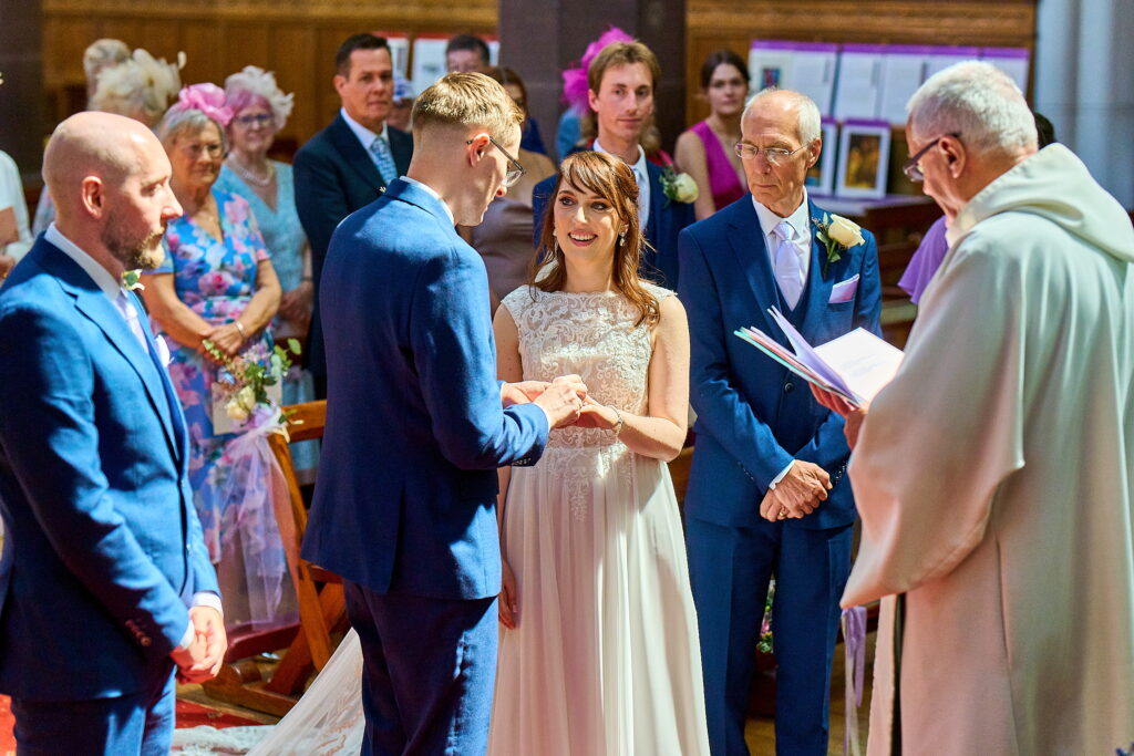 Master wedding photographer Jonathon Dow capturing a bride and groom holding hands.