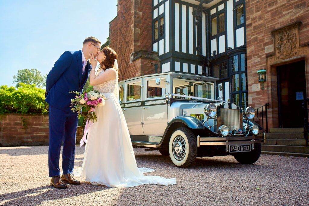 A romantic moment of a bride and groom kissing, captured by Master Photographer Jonathon Dow.