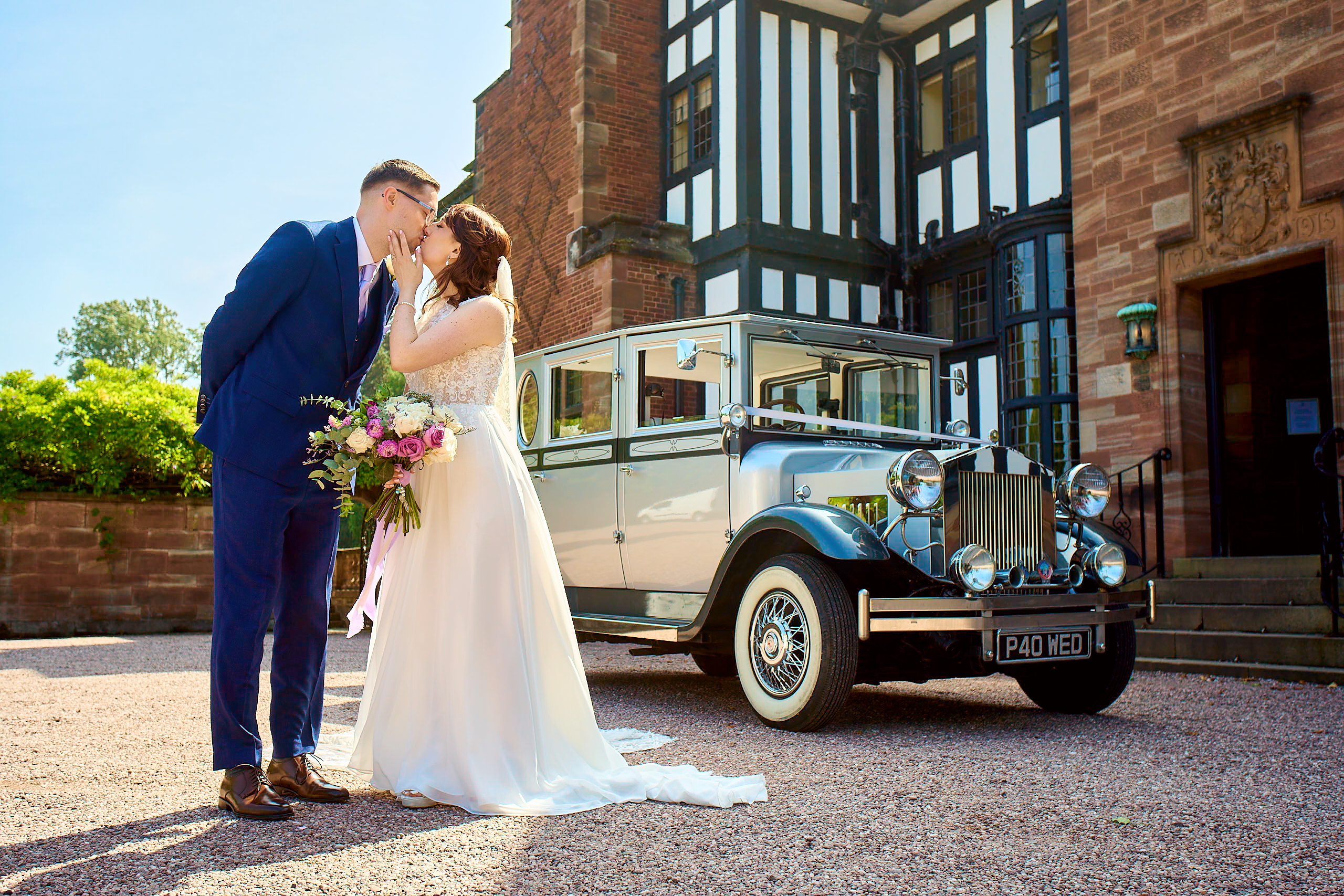 A romantic moment of a bride and groom kissing, captured by Master Photographer Jonathon Dow.