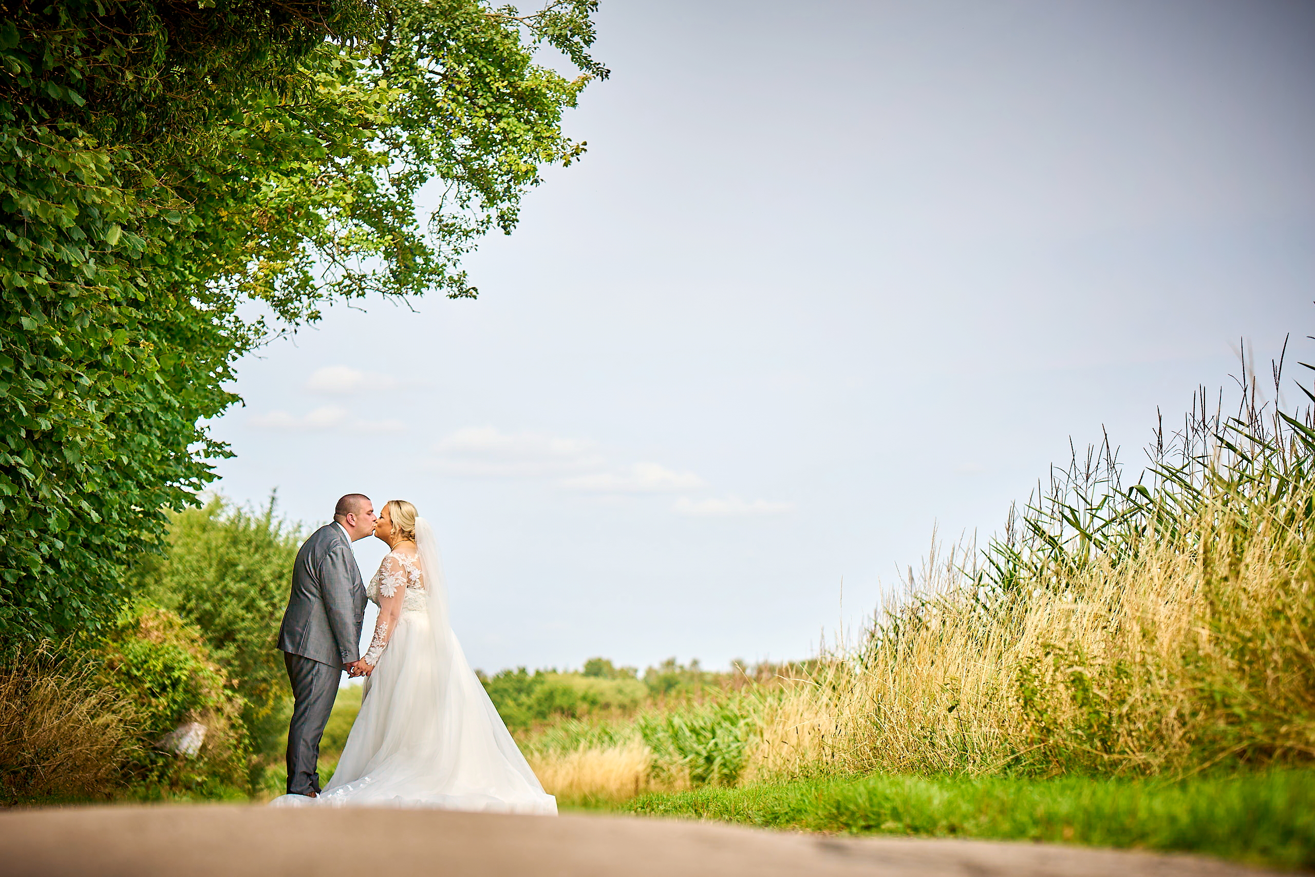 A beautiful moment of a newly married couple kissing at a Warwickshire wedding venue.