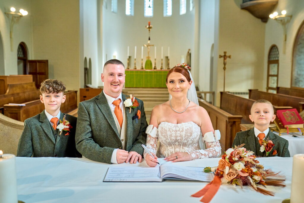 Bride & Groom signing the register at the Altar in Church